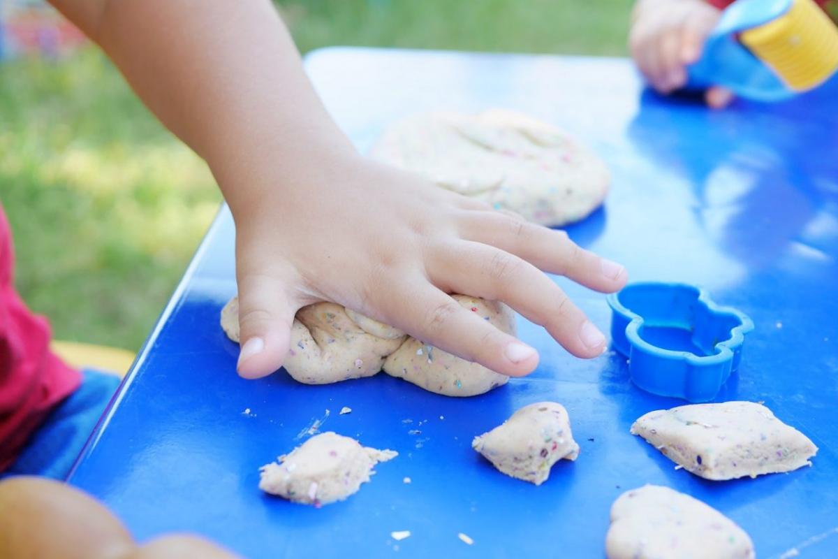 Toddler's hand smashing play dough